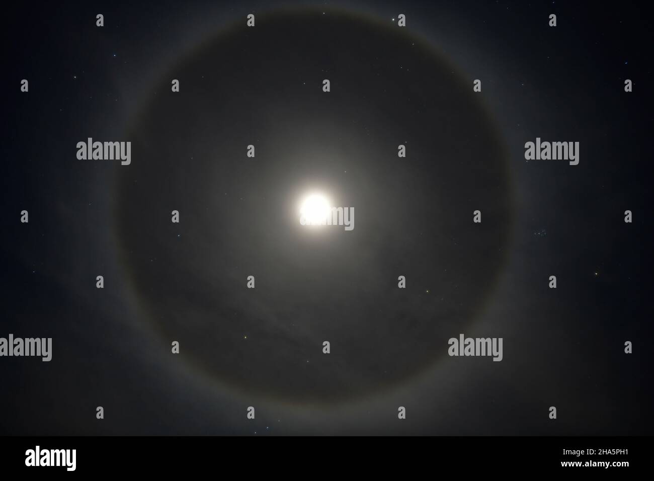 the full moon with a halo ring in the clear sky,småland,sweden Stock Photo