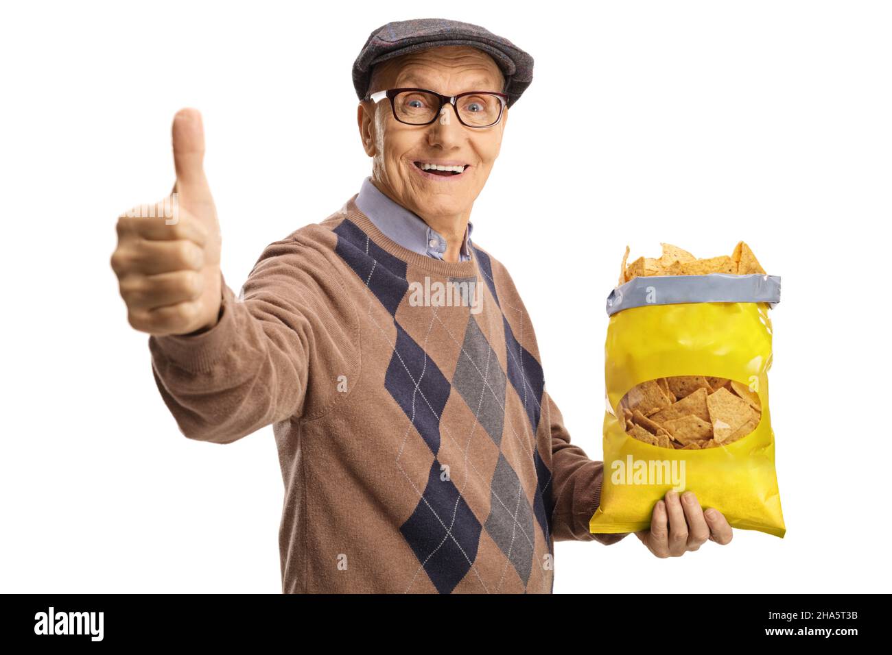 Cheerful elderly man holding a pack of tortilla chips and showing thumbs up isolated on white background Stock Photo