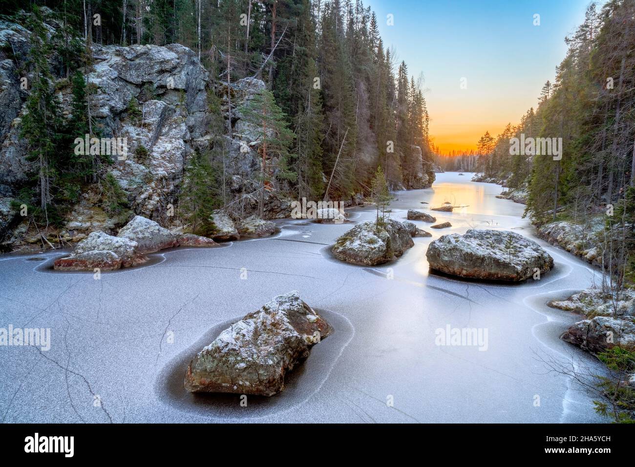 river with rock and ice,trees and sunrise Stock Photo