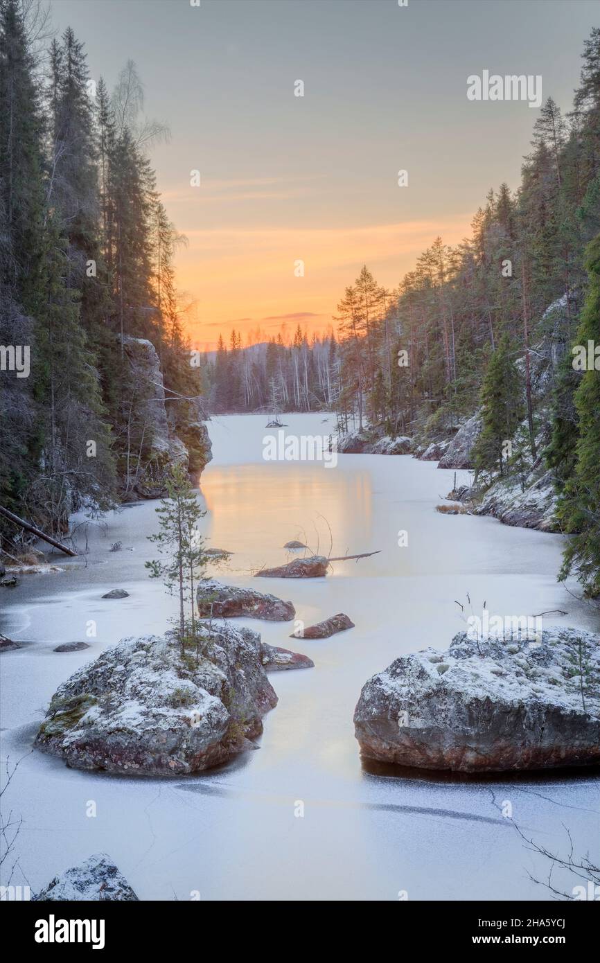 river with rock and ice,trees and sunrise Stock Photo