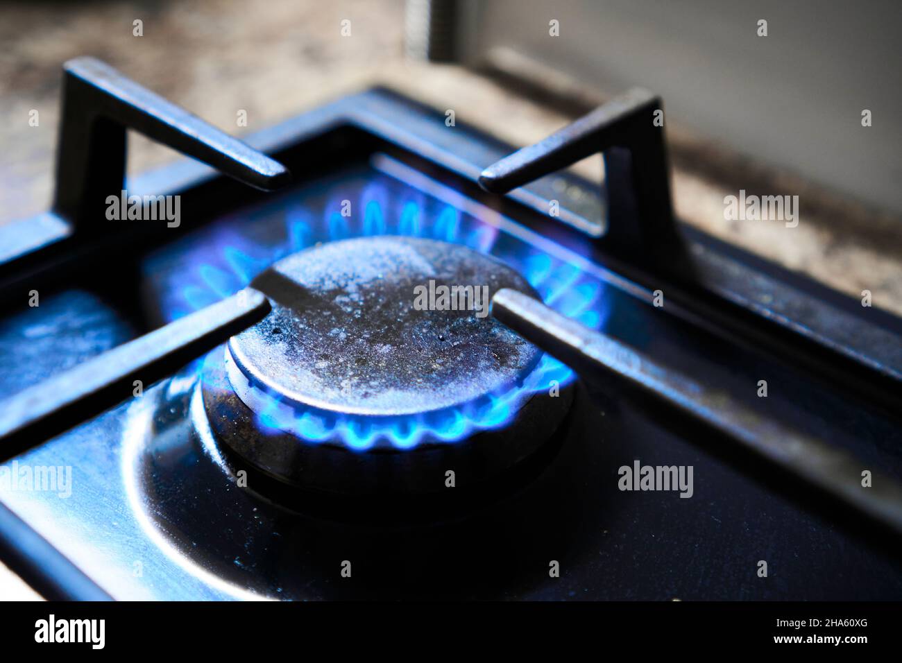 Cooker as heater. Blue flame from gas hob produce greenhouse gas