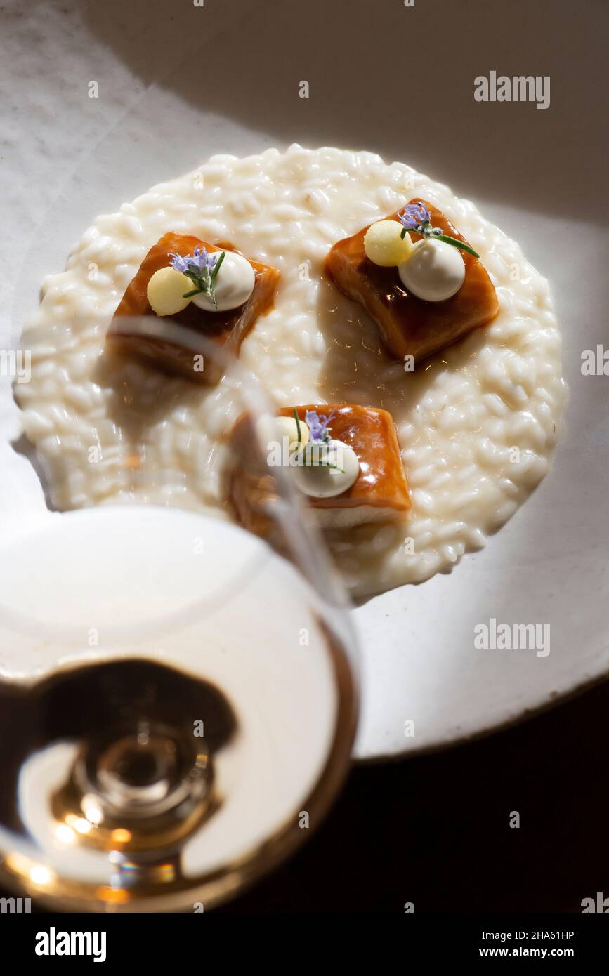 italy,trentino-south tyrol,alto adige,south tyrol,meran,district community burggrafenamt,algund,inn zur blauen traube,risotto from south tyrolean golden delicious apple with flamed smoked eel Stock Photo