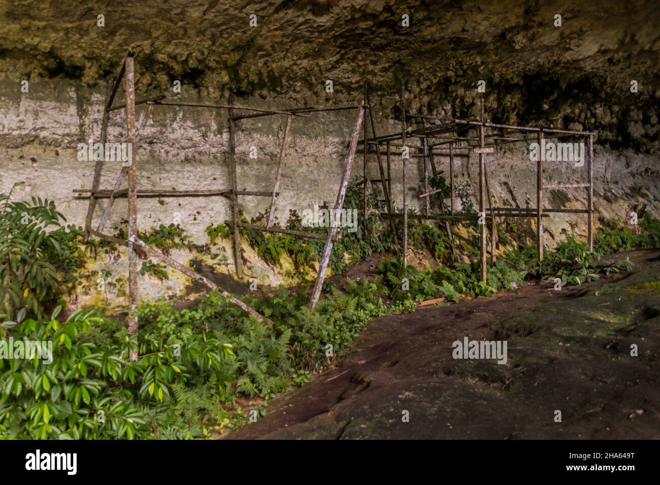 Cave with old wooden buildings remnants in the Niah National Park, Malaysia Stock Photo