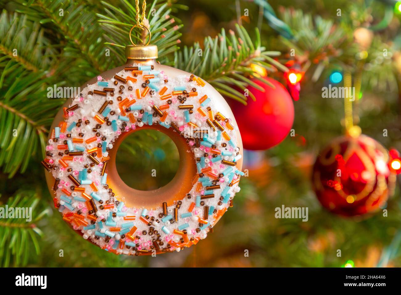 Glass Christmas donut hanging on the Christmas tree. Stock Photo