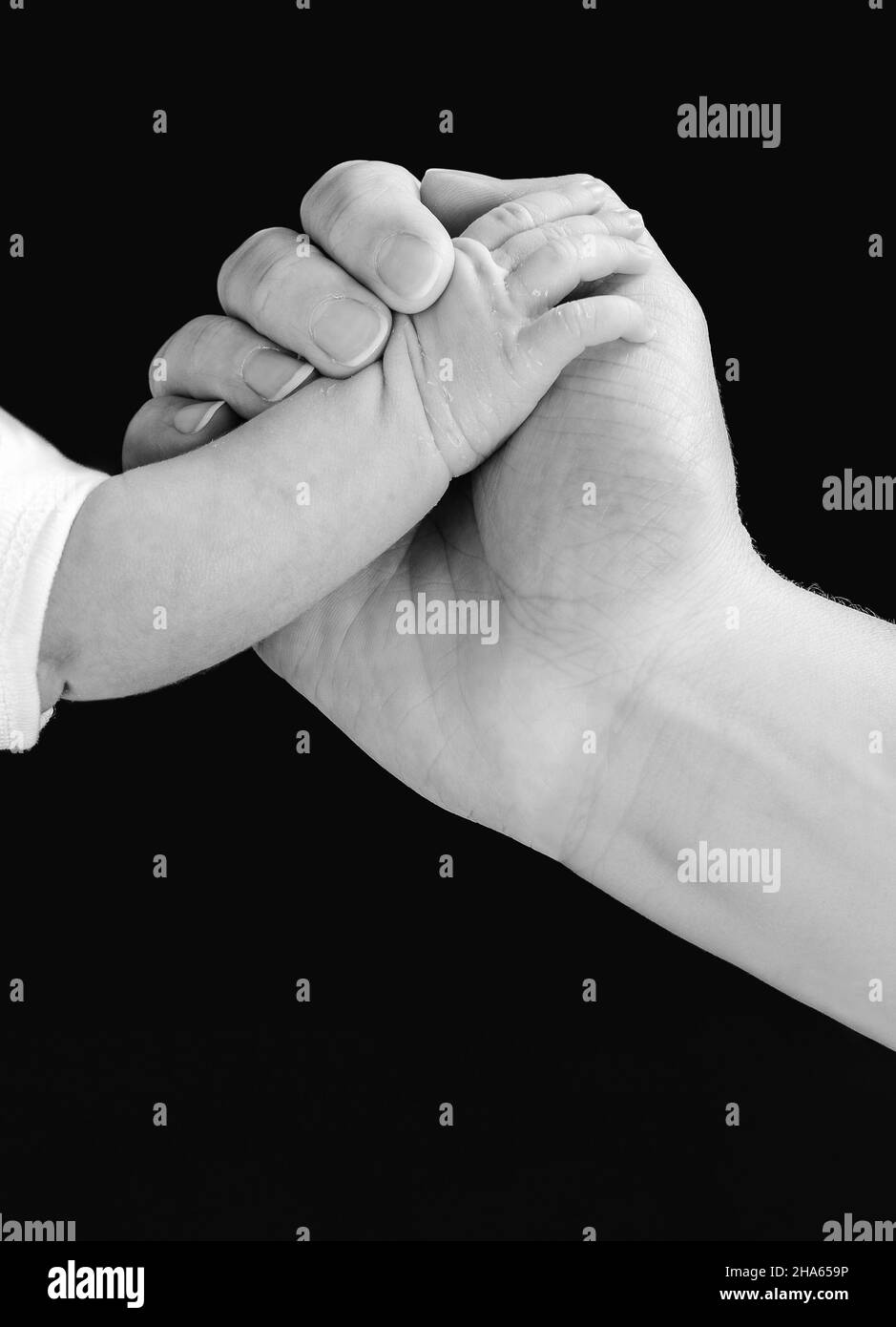 Hand of an adult person holding the little hand of a baby isolated on ...