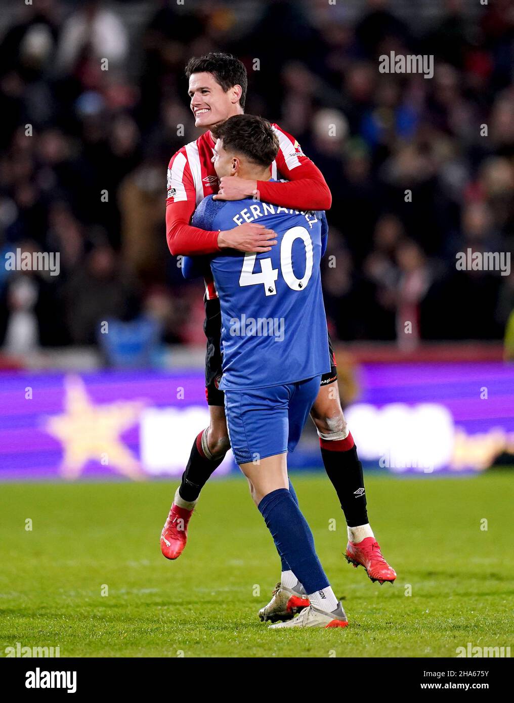 Brentford goalkeeper Alvaro Fernandez (right) celebrates with team-mate Christian Norgaard at the end of the Premier League match at the Brentford Community Stadium, London. Picture date: Friday December 10, 2021. Stock Photo