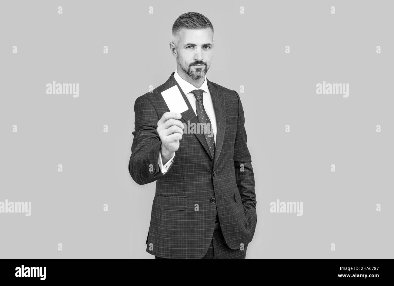 businessman demonstrating credit or debit card. empty plastic business name card. Stock Photo