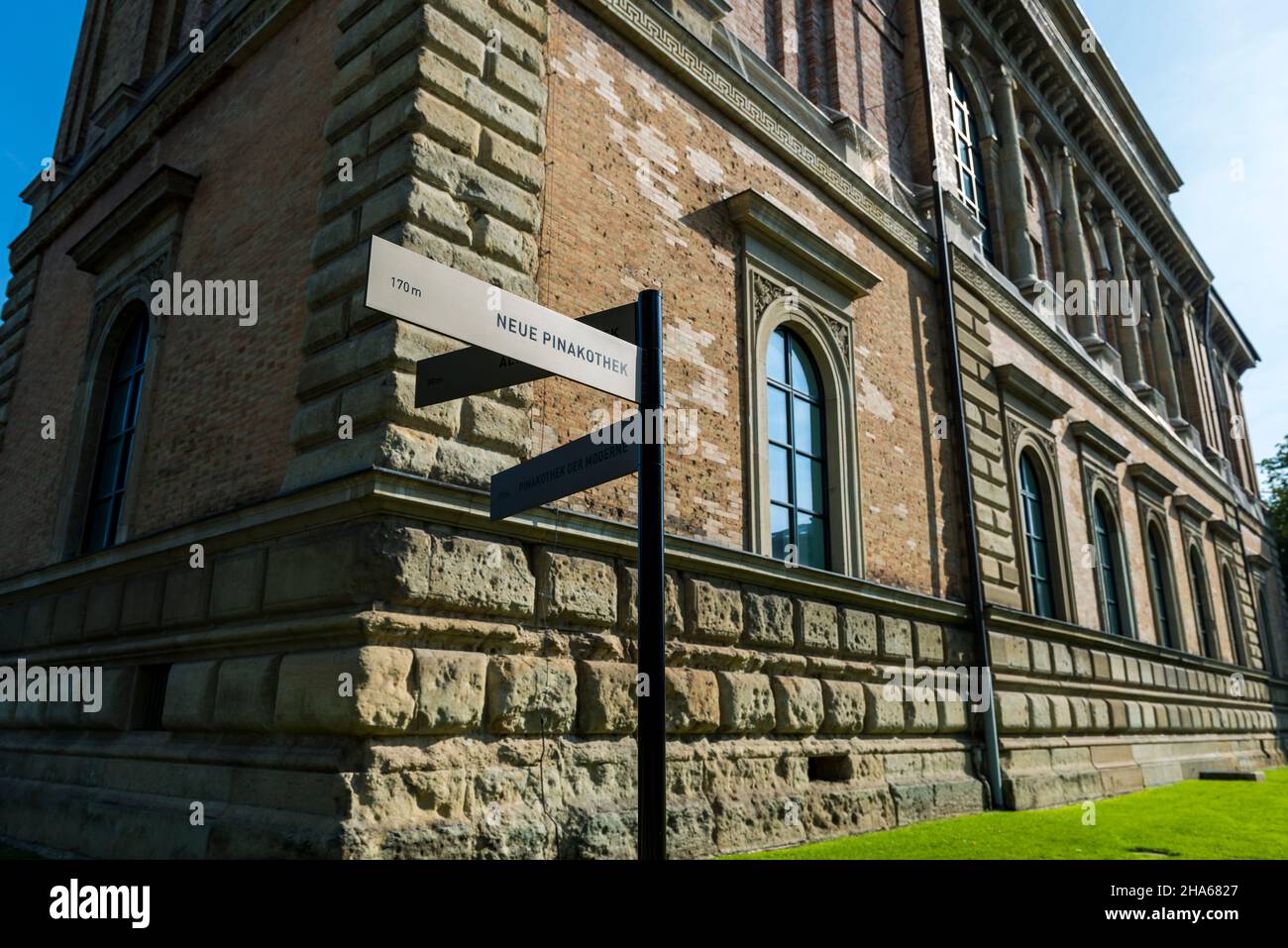 signpost to the new pinakothek in munich in front of the old pinakothek Stock Photo