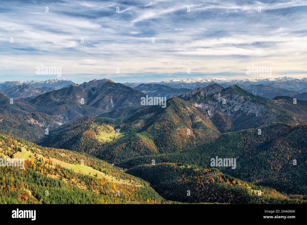 view from the risserkogel over the bavarian prealps to the wilder kaiser and hohen tauern on a sunny day in autumn. mountains,hills and forests under a blue sky. mangfall mountains,bavaria,germany,tyrol,austria,europe Stock Photo