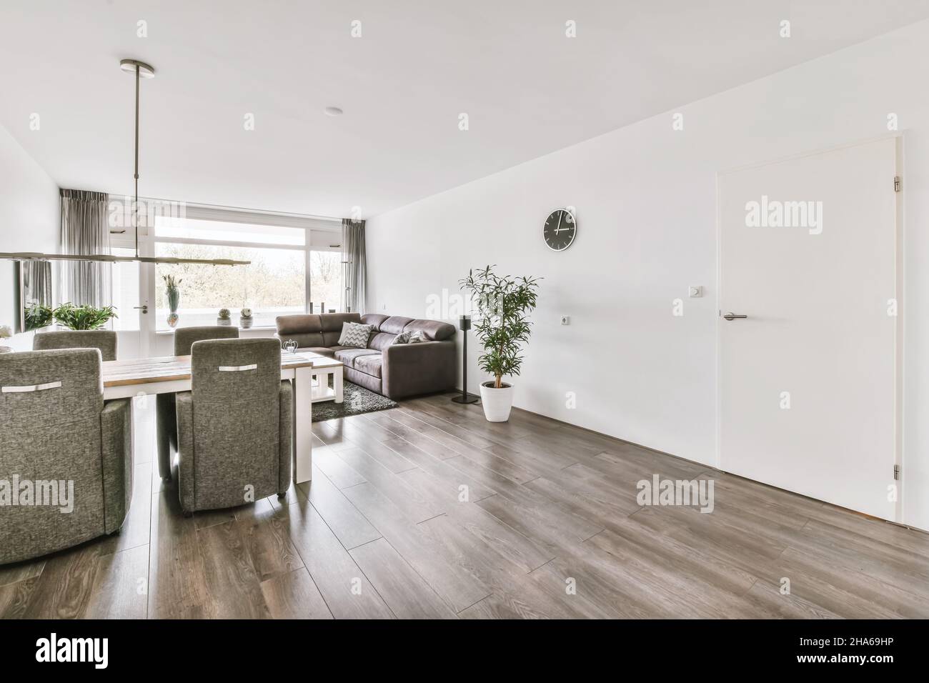 Stylish living room combined with a dining area with upholstered