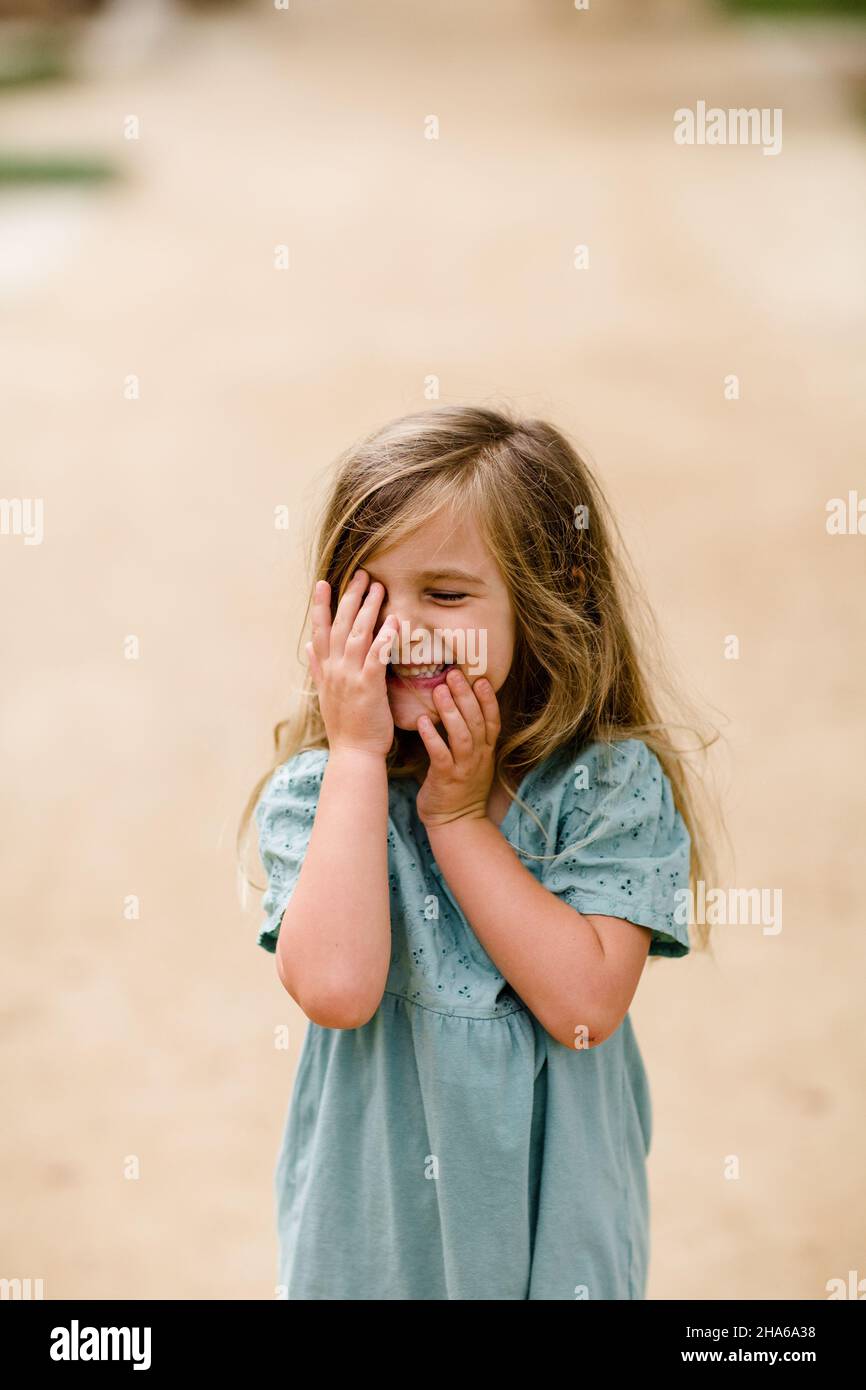 Four Year Old Touching Face & Giggling in San Diego Stock Photo - Alamy