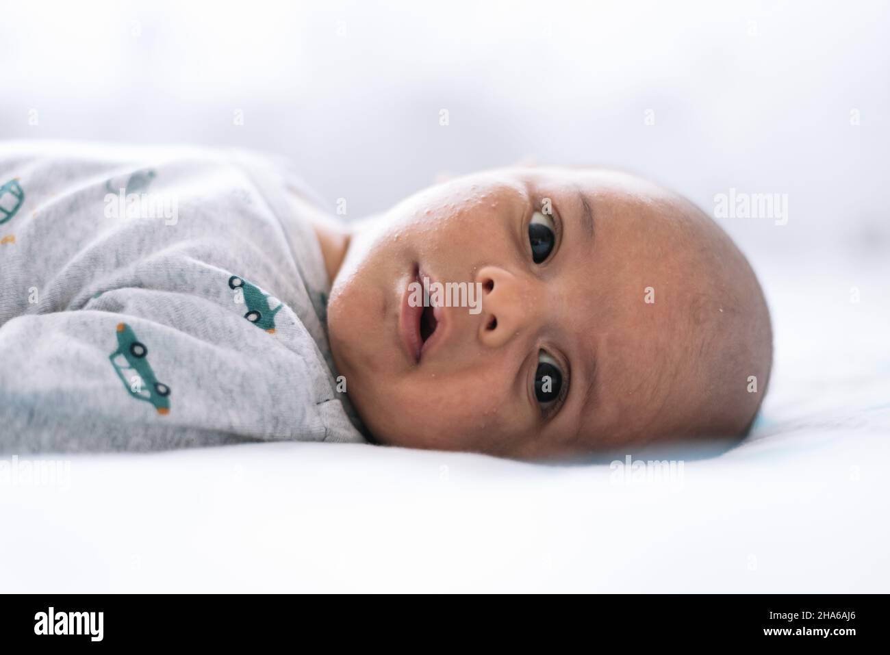 Onemonthold baby lying in bed Stock Photo Alamy