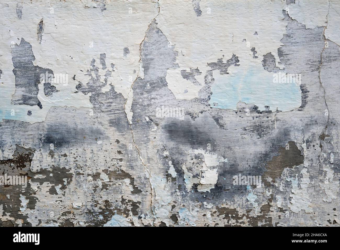 Old weathered wall with damp peeled lime wash plaster finish Stock Photo