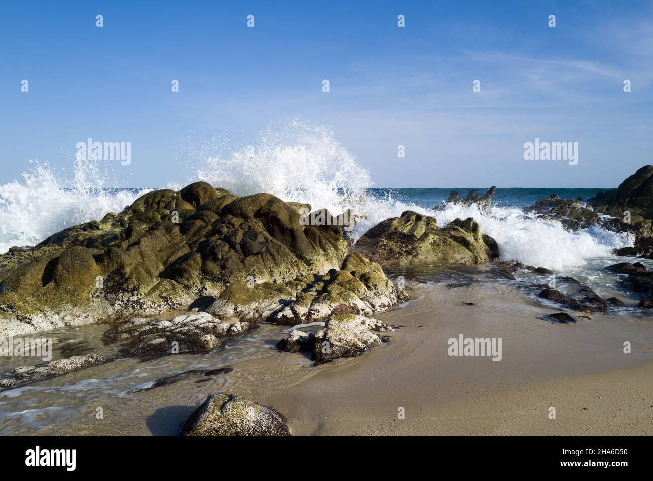 Ocean waves roll in and splash upon the rocky shore Stock Photo - Alamy