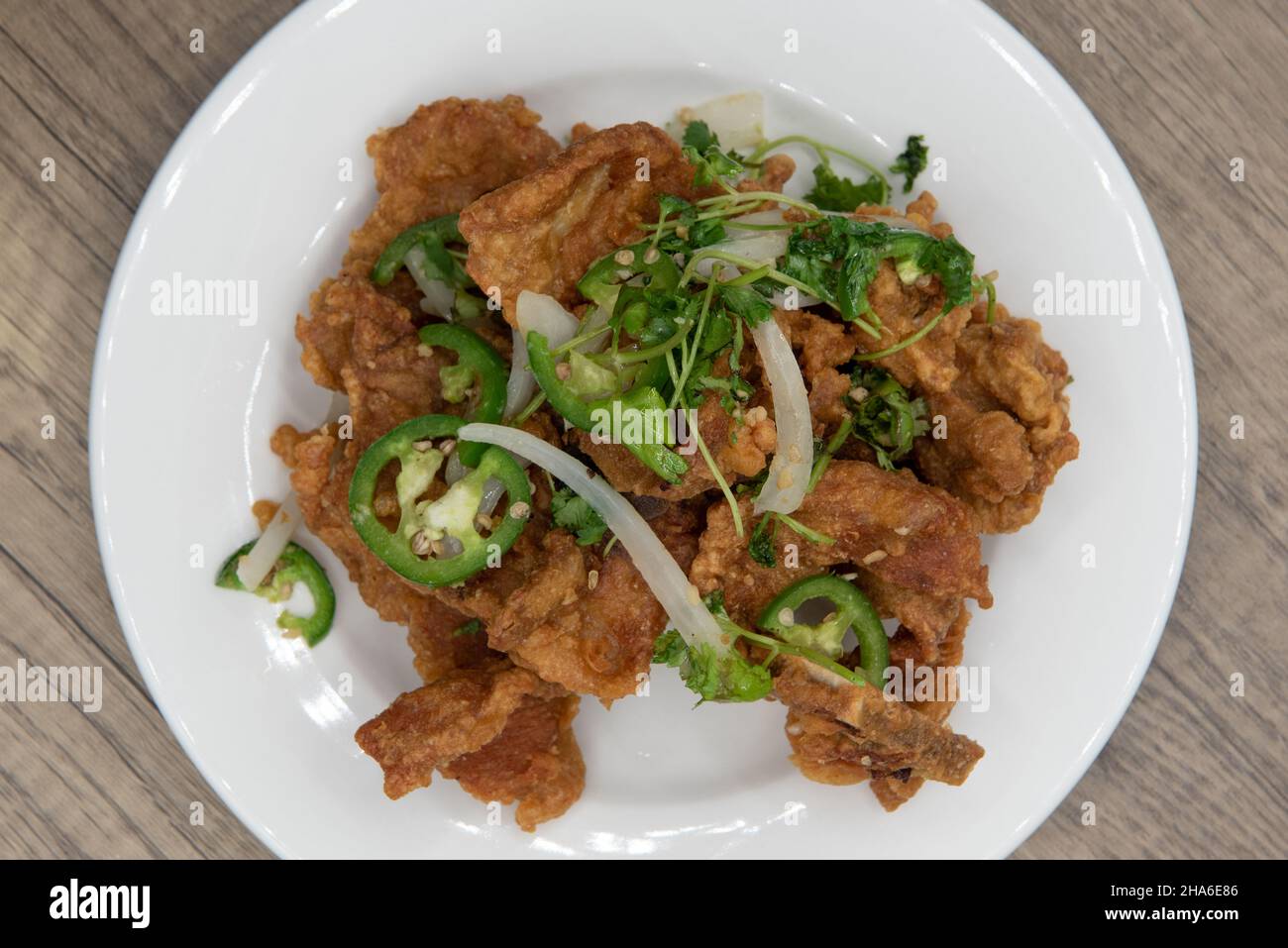 Overhead view of tall pile of crispy deep fried salt and pepper ribs for some spicy and crunchy