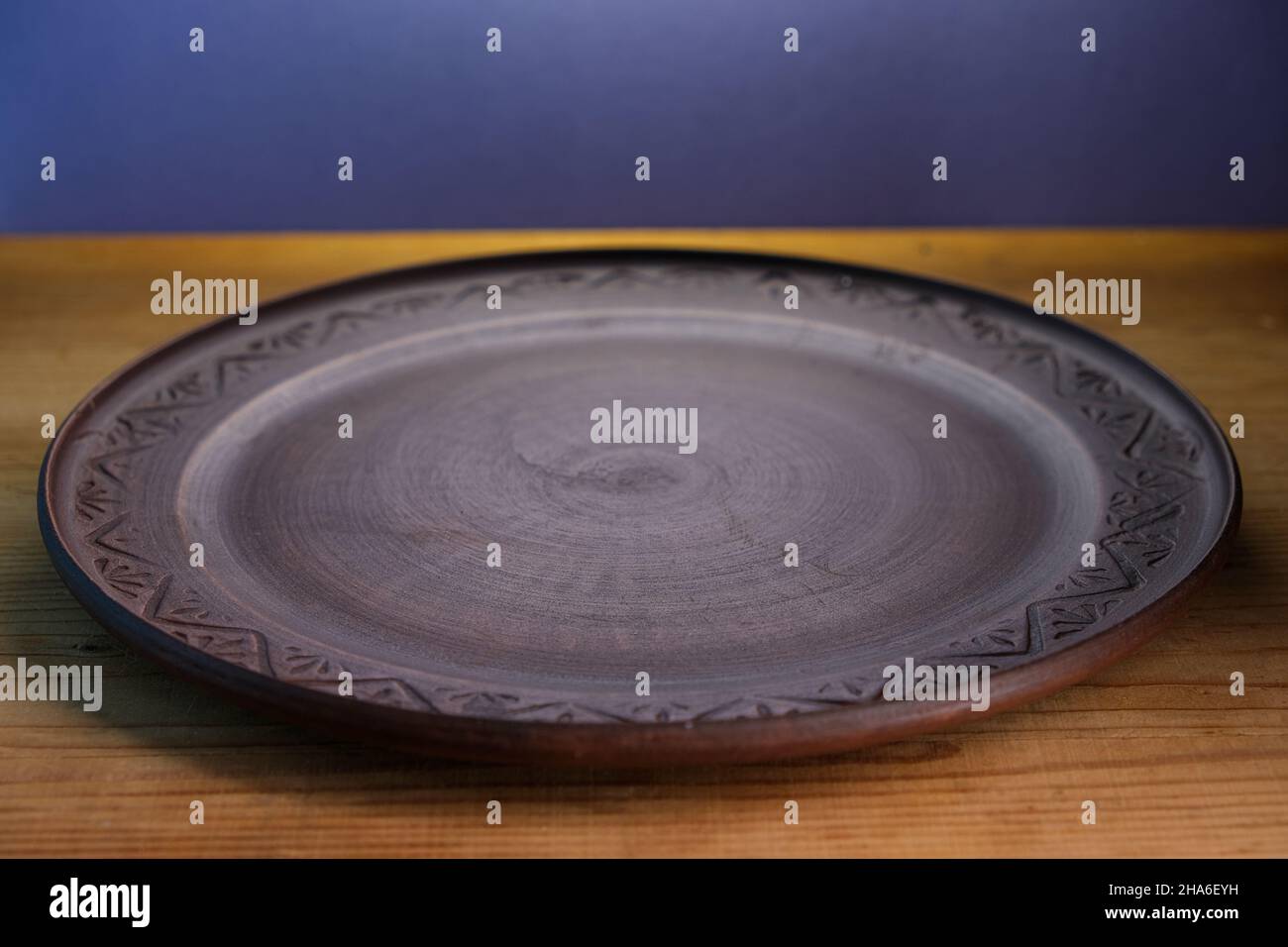 Brown plate on a wooden surface. Stock Photo