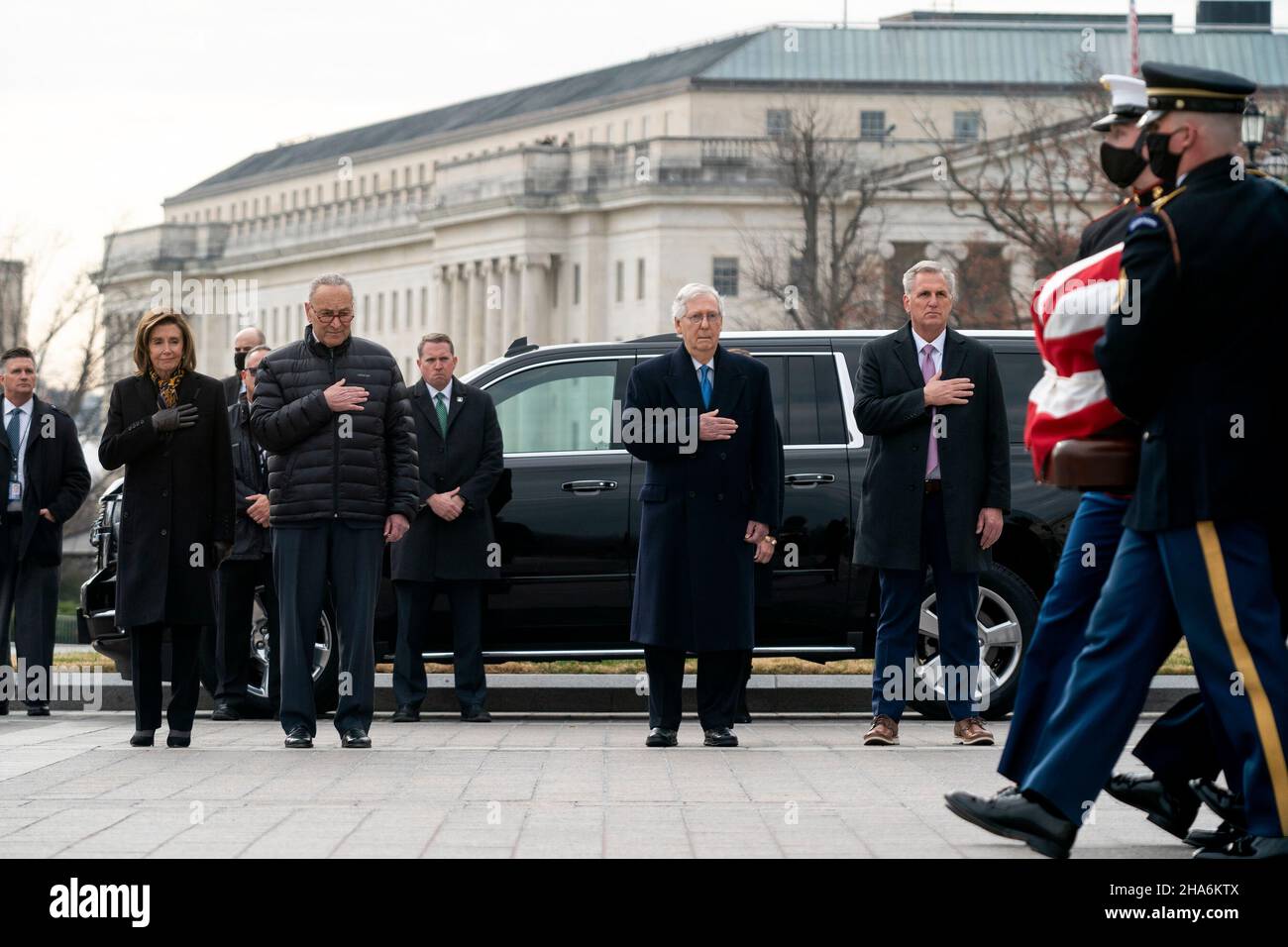 Washington, DC. 10th Dec, 2021. Speaker Nancy Pelosi (D-Calif.), Majority Leader Charles Schumer (D-N.Y.), Minority Leader Mitch McConnell (R-Ky.) and House Minority Leader Kevin McCarthy (R-Calif.) watch a military honor guard carries the casket of Sen. Bob Dole (R-Kan.) after lying in state at the U.S. Capitol in Washington, DC, on Friday, December 10, 2021. Dole will be taken to Washington National Cathedral for a funeral service. Credit: Greg Nash/Pool via CNP/dpa/Alamy Live News Stock Photo