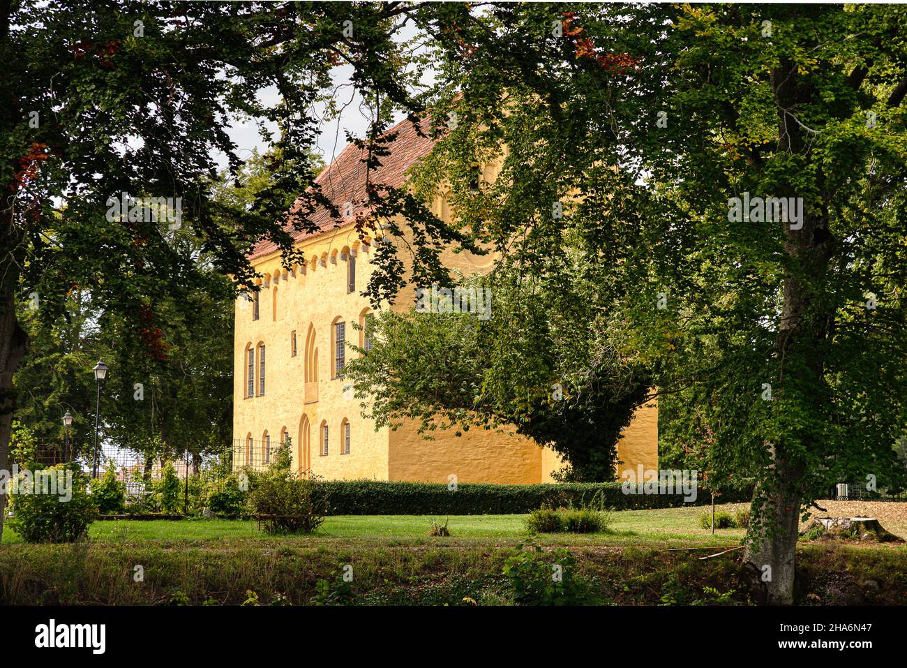 the yellow castle  Bollerup among the trees, Bollerup, Sweden, September 15, 2021 Stock Photo
