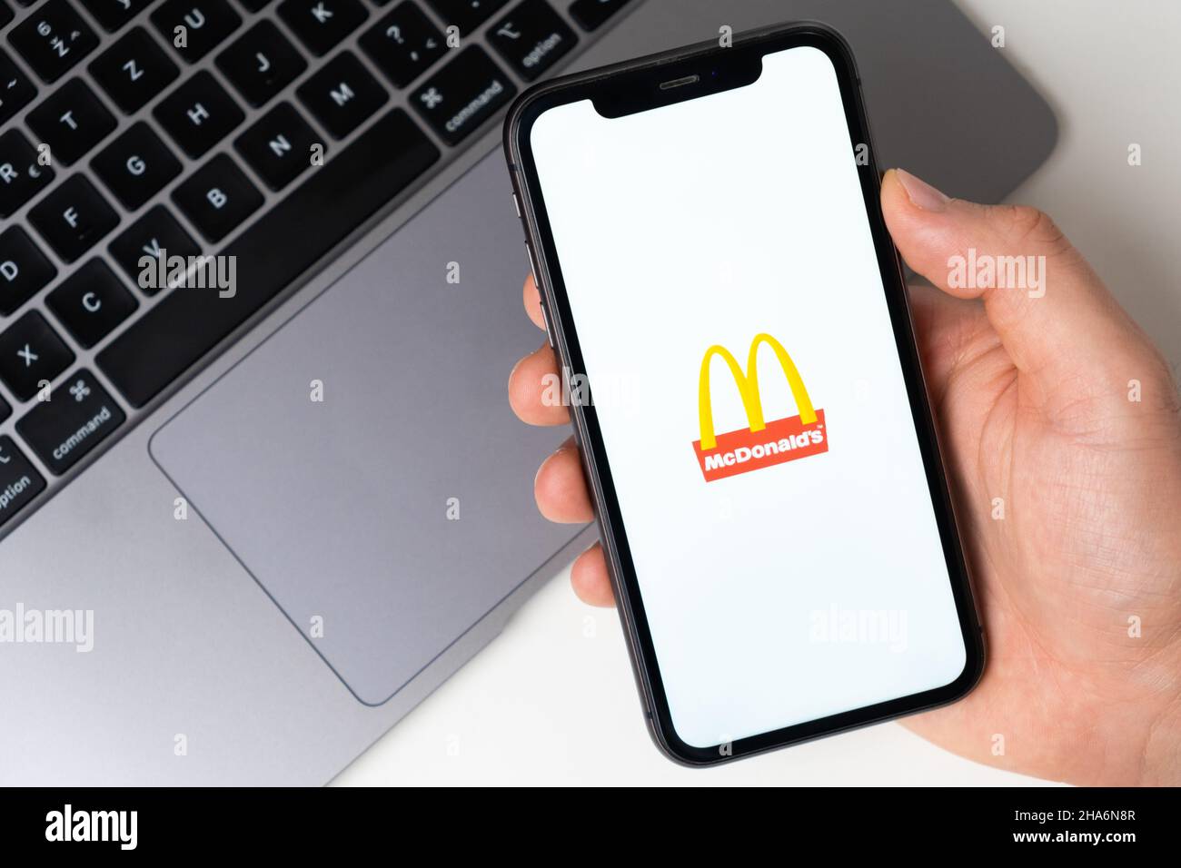 McDonalds the application is open in the smartphone. The man is holding a mobile phone in his hand, the company application is open on the screen. Secure online shopping. November 2021, San Francisco, USA Stock Photo