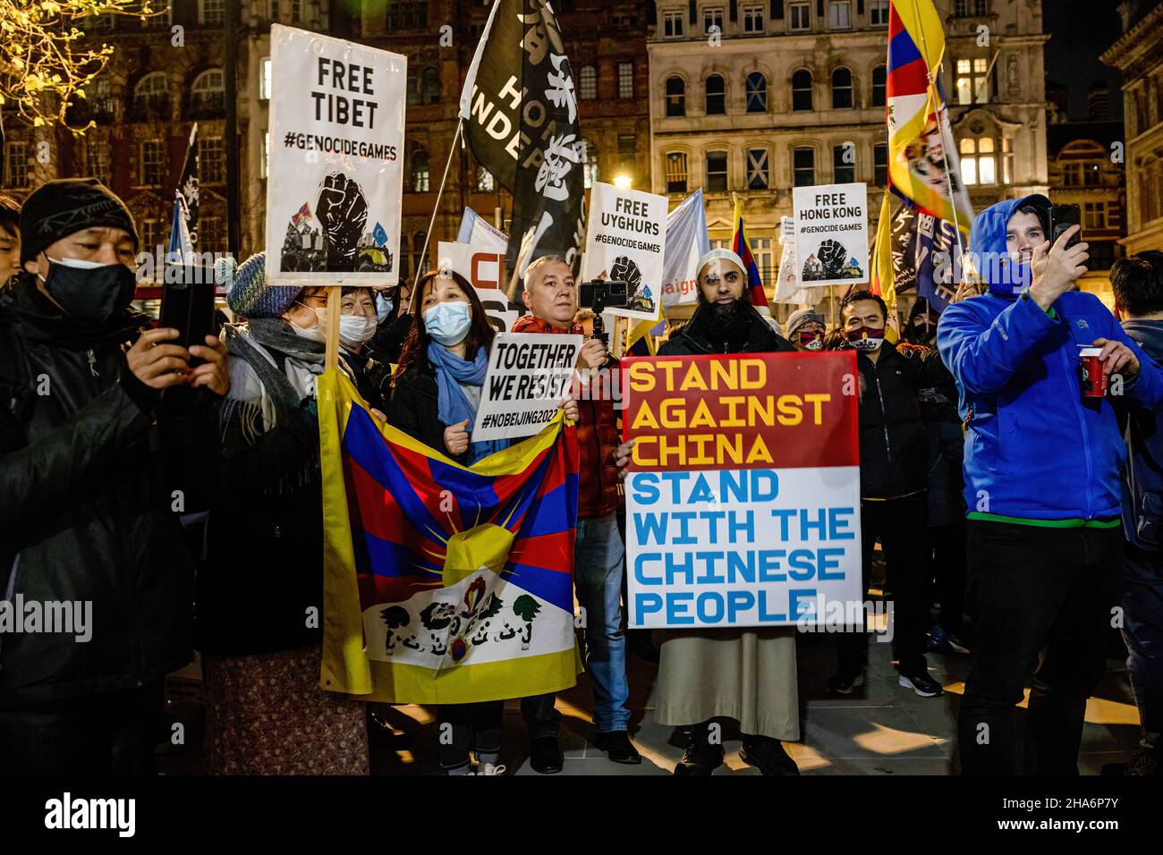 London, UK. 10th Dec, 2021. London, UK. 10th Dec, 2021. A crowd of protesters hold flags and placards during the rally. Various anti-Chinese Communist Party (anti-CCP) communities in London rallied at Piccadilly Circus, later marched to 10 Downing Street. Hong Kongers, Tibetans and Uighurs came together to condemn the attempts from the CCP to oppress dissenting voices. Protesters also demanded the Western world to boycott the 2022 Beijing Winter Olympic games in response to the suppression of human rights in China. Stock Photo