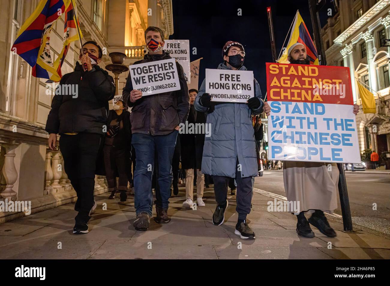 London, UK. 10th Dec, 2021. London, UK. 10th Dec, 2021. Protesters, including exile Hongkonger Simon Cheng, lead others in a protest march while holding placards during the rally. Various anti-Chinese Communist Party (anti-CCP) communities in London rallied at Piccadilly Circus, later marched to 10 Downing Street. Hong Kongers, Tibetans and Uighurs came together to condemn the attempts from the CCP to oppress dissenting voices. Protesters also demanded the Western world to boycott the 2022 Beijing Winter Olympic games in response to the suppression of human rights in China. Stock Photo