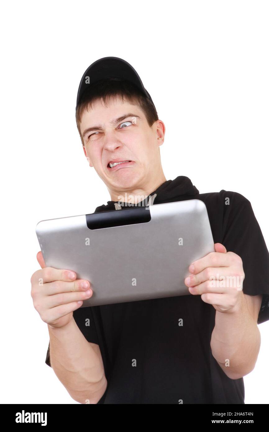 Annoyed Teenager with Tablet Computer Isolated on the White Background Stock Photo