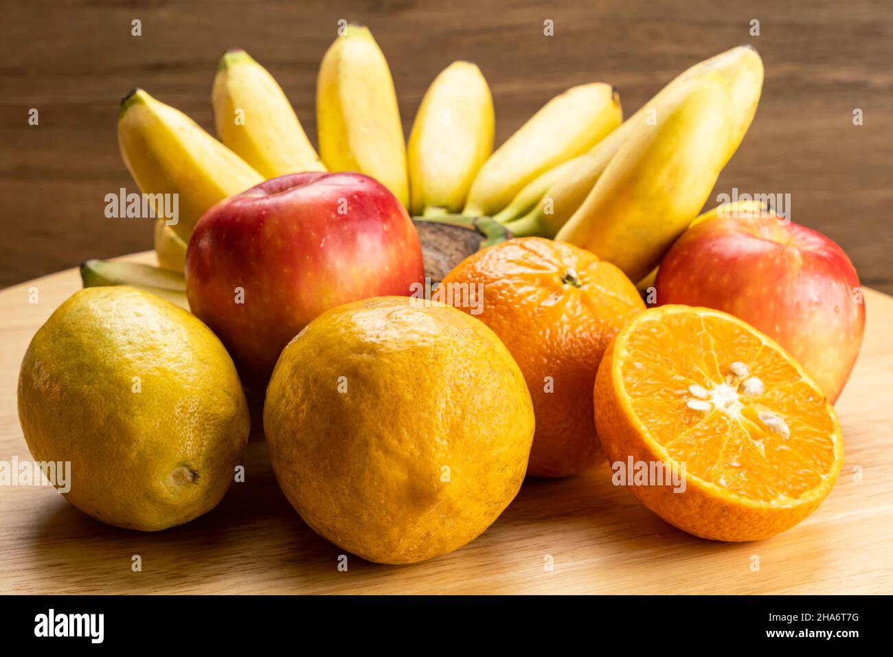Assorted ripe tropical fruit on wooden board. Various ripe sweet fruit ...