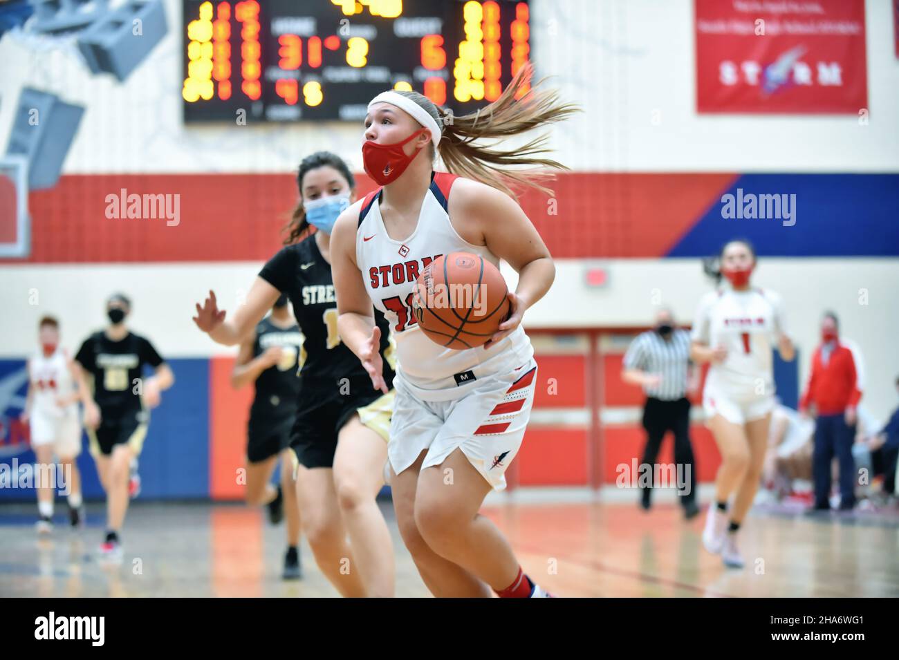 USA. Player finishing off an offensive drive during a high school basketball game. Stock Photo