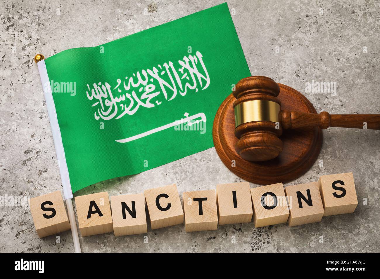 Saudi Arabia flag, Judge hammer and wooden cubes with text, concept on the theme of country sanctions Stock Photo