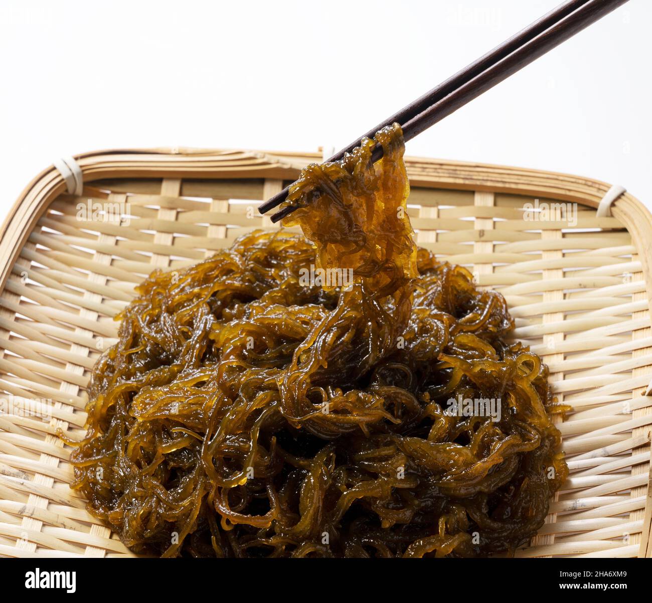 Mozuku in a colander on a white background.Mozuku is an Okinawan ...