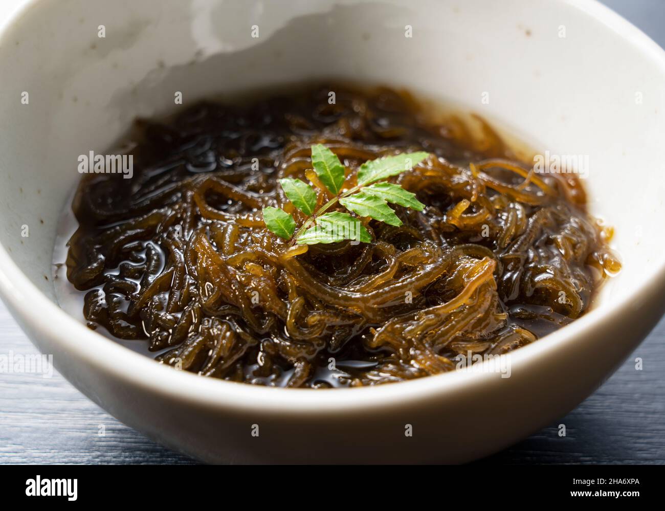 A mozuku seaweed placed on a black background.Mozuku is an Okinawan
