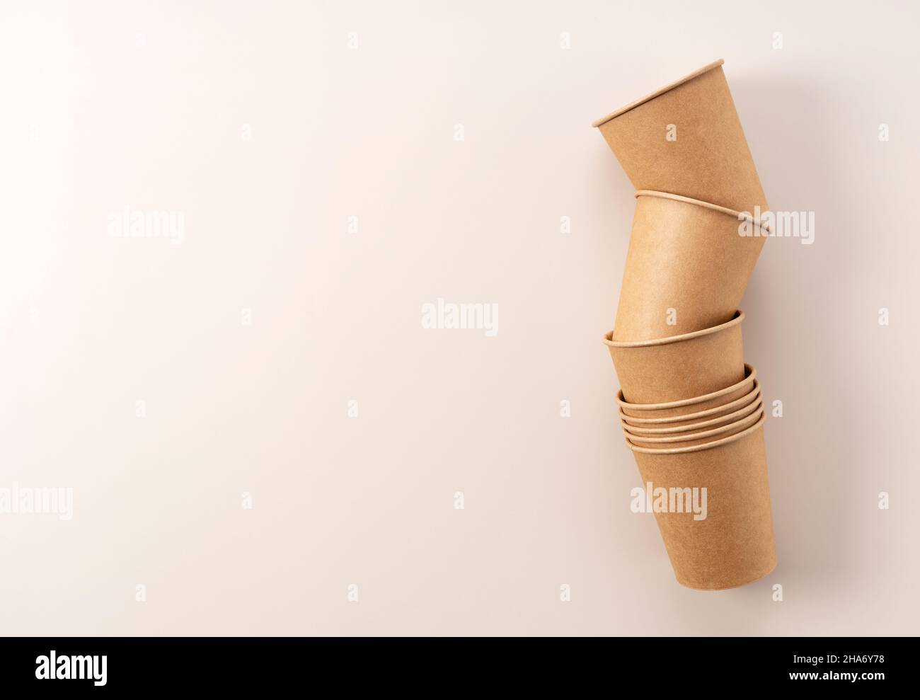 Disposable paper cups on a beige background. A zero-waste concept. View ...