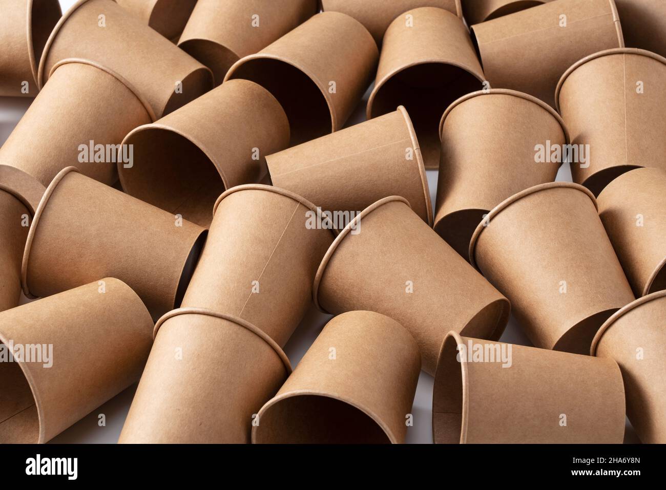 A lot of brown recycled paper cups on a white background. The zero ...