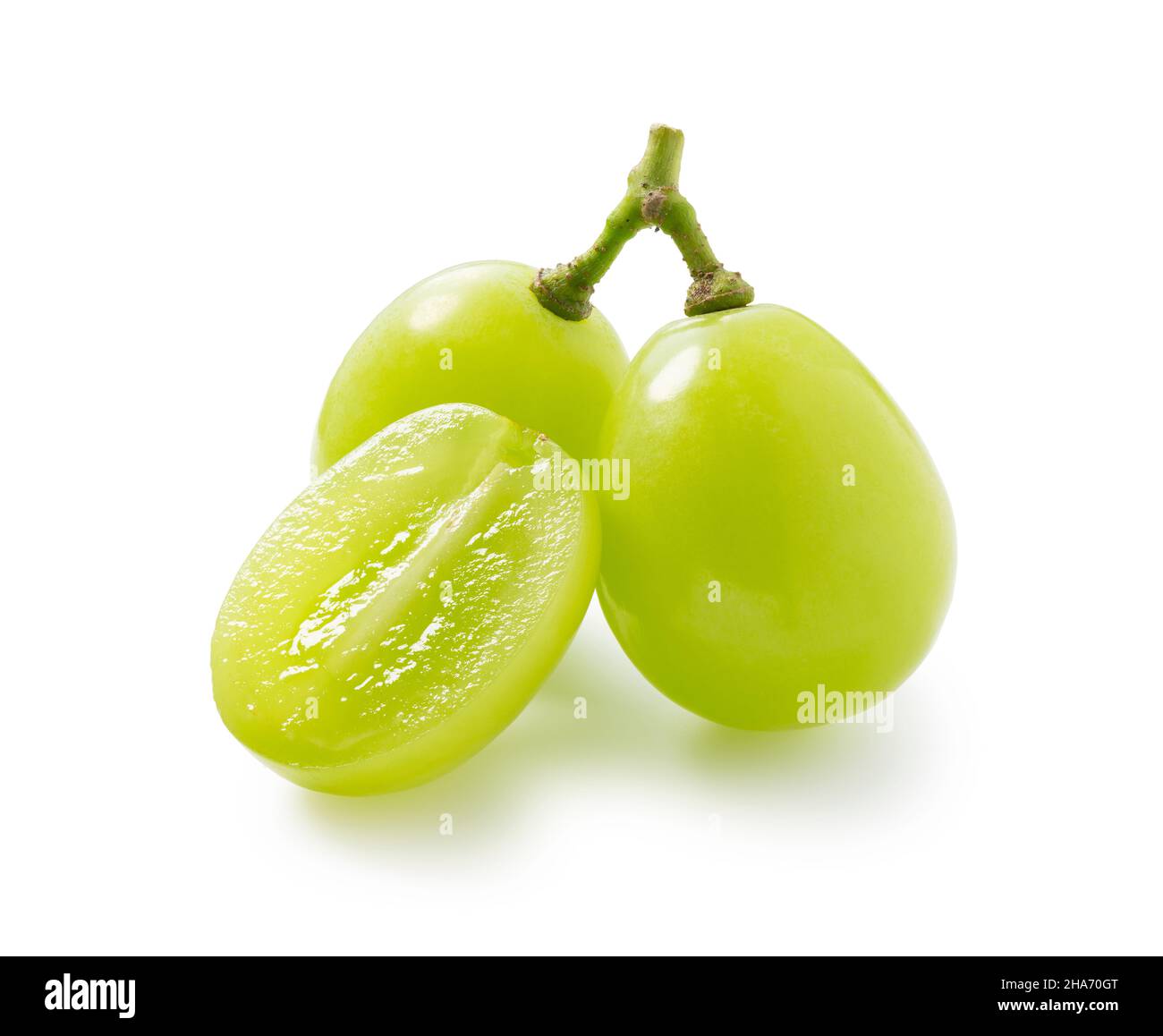 Grains of shine muscat grapes and cut shine muscat grapes on a white