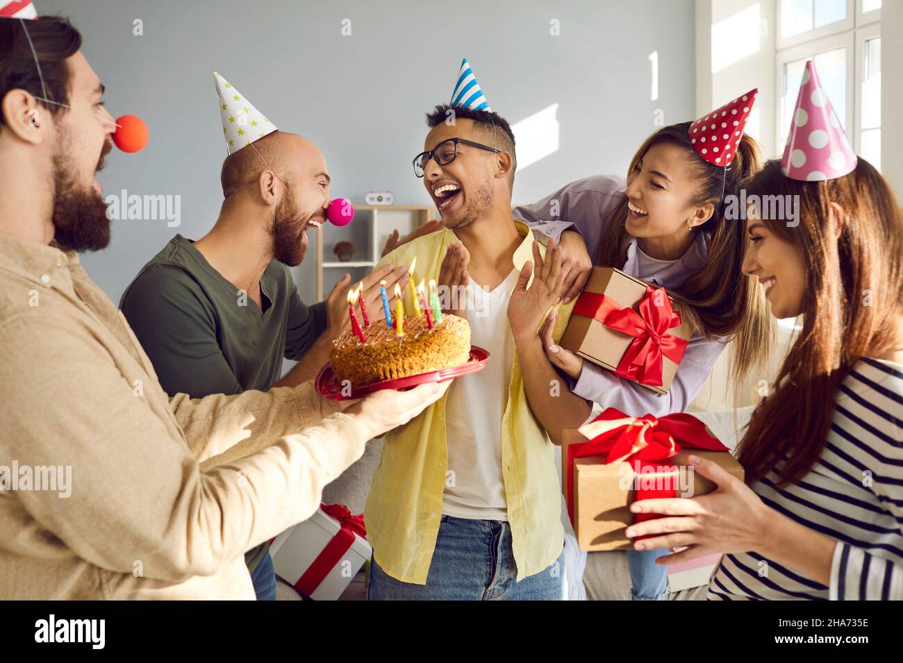 Smiling diverse people congratulate friend with happy birthday Stock Photo