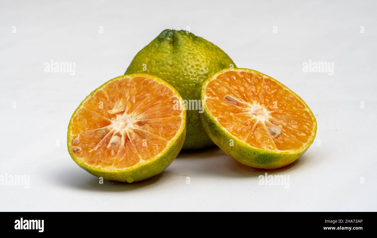 Fresh green tangerine fruit and juice on white background, Healthy fruits Stock Photo