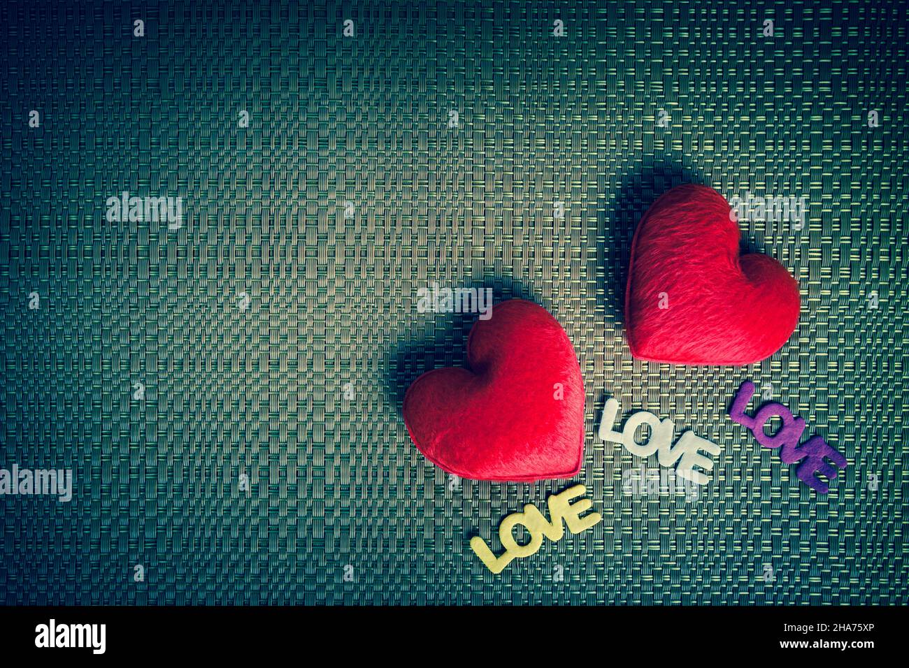 Two red hearts and text "LOVE" on the texture background for a ...