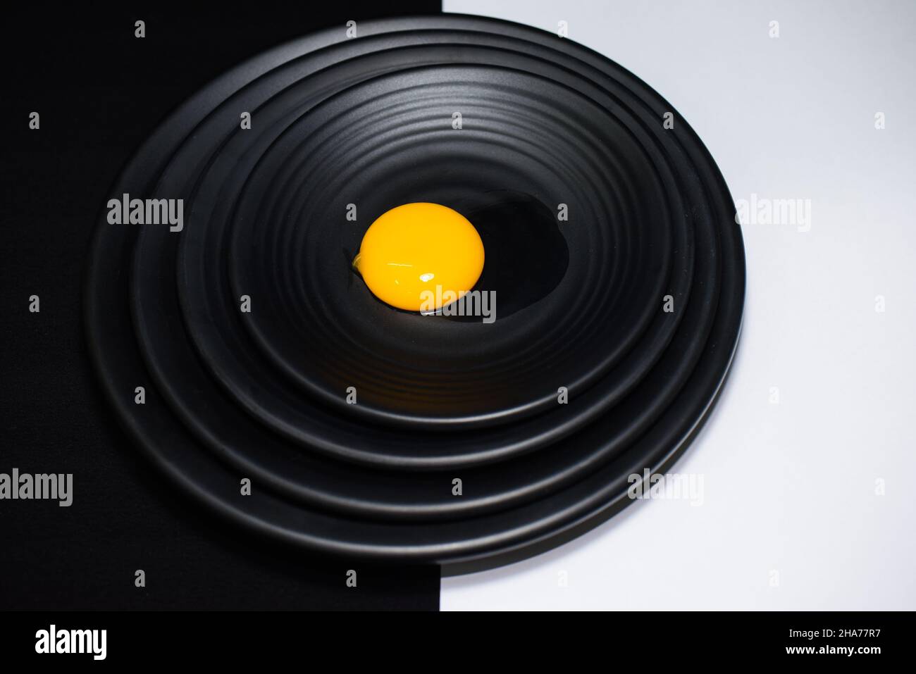 Chicken egg on a black background Stock Photo - Alamy