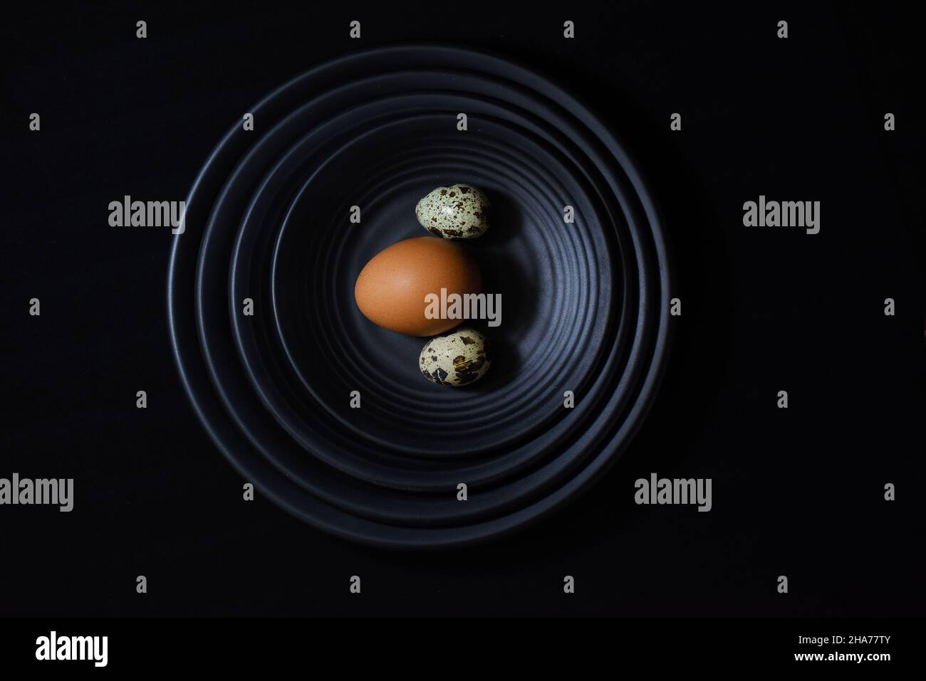 Chicken eggs with shells on a black background Stock Photo - Alamy