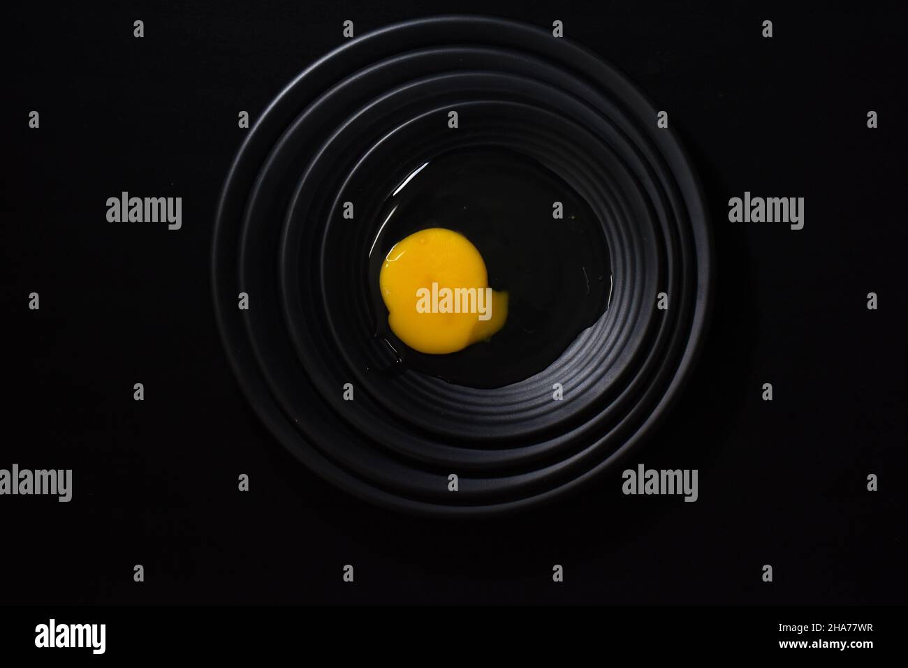 Chicken egg on a black background Stock Photo - Alamy