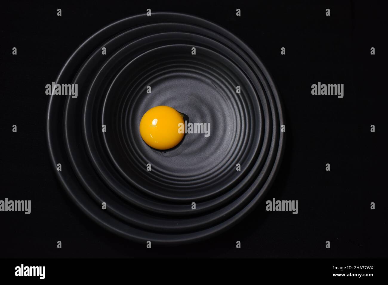 Chicken egg on a black background Stock Photo - Alamy