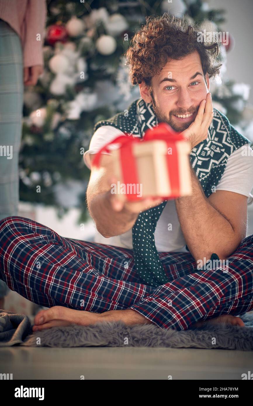 Happy caucasian man opening gifts on a Christmas morning Stock Photo