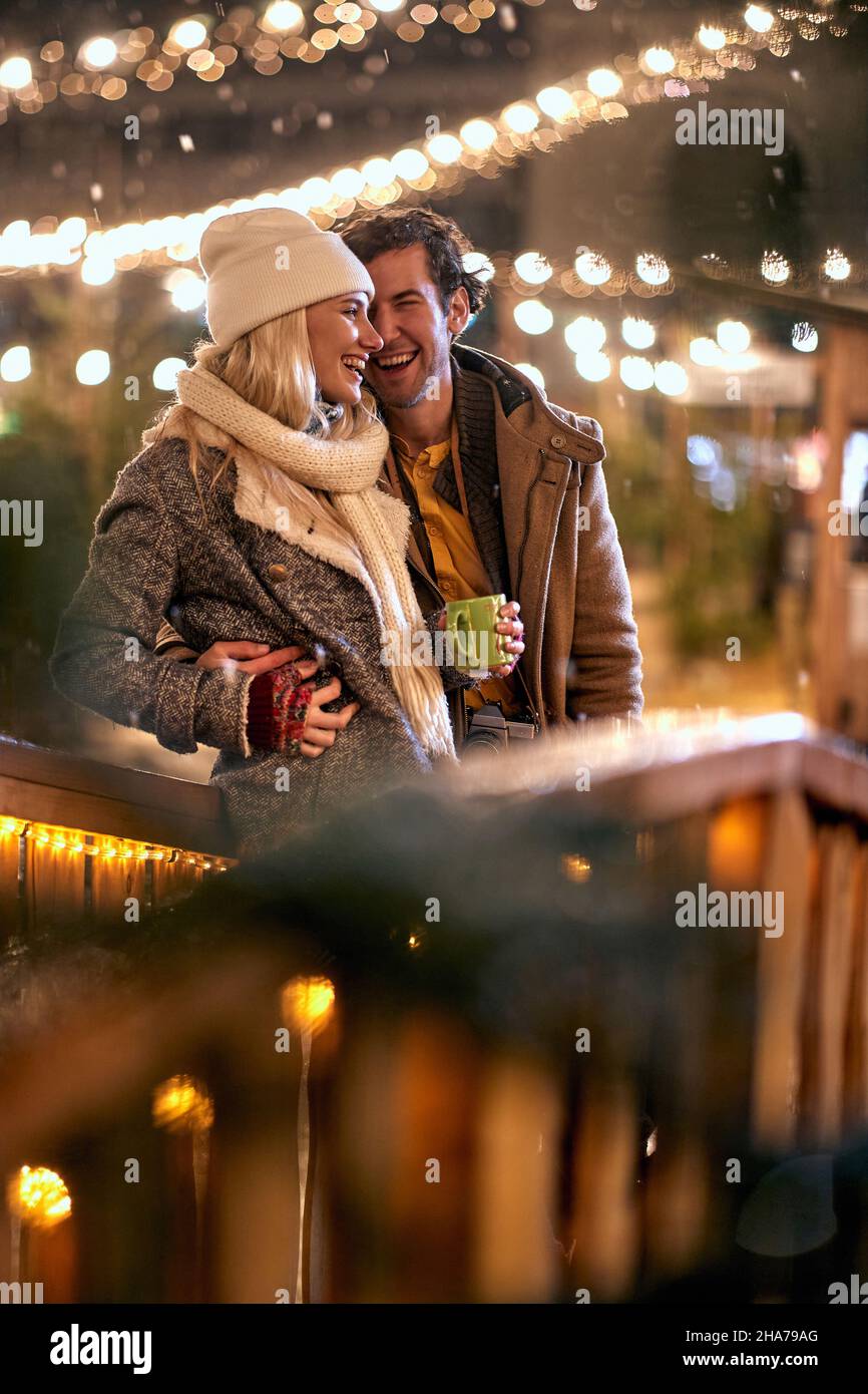 Romantic man and woman in Christmas night together Stock Photo