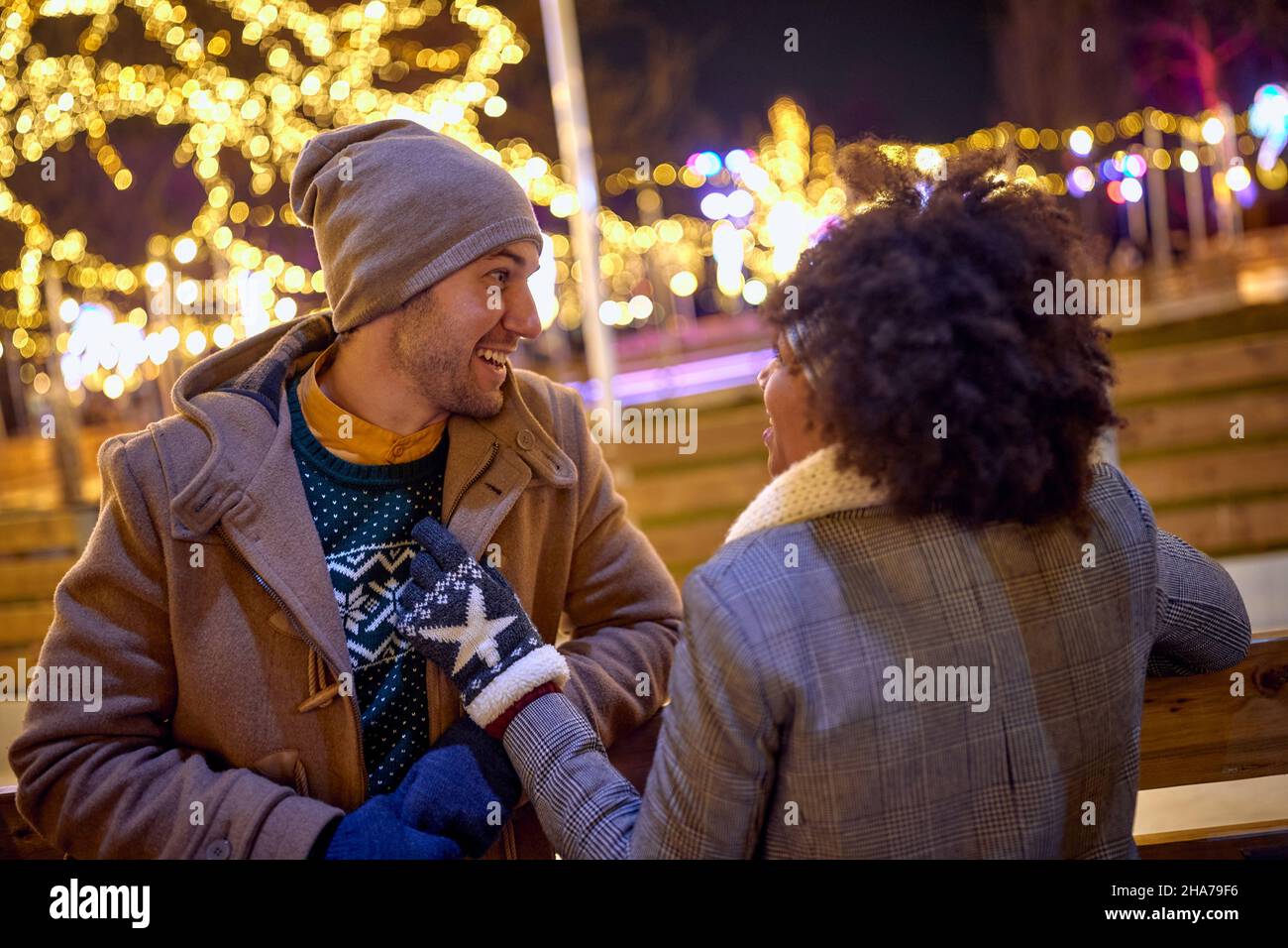 Romantic man and woman  dating  at night Street Decorated With Winter Lights Stock Photo