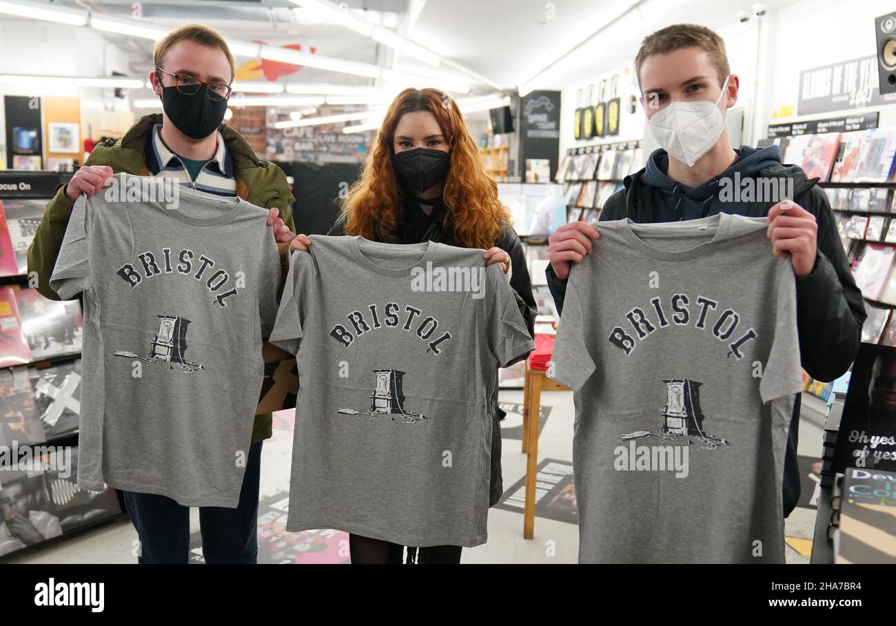 Customers in Rough Trade in Bristol, with a T-shirt designed by street artist Banksy being sold to support four people facing trial accused of criminal damage in relation to the toppling of a statue of slave trader Edward Colston. Picture date: Saturday December 11, 2021. Stock Photo