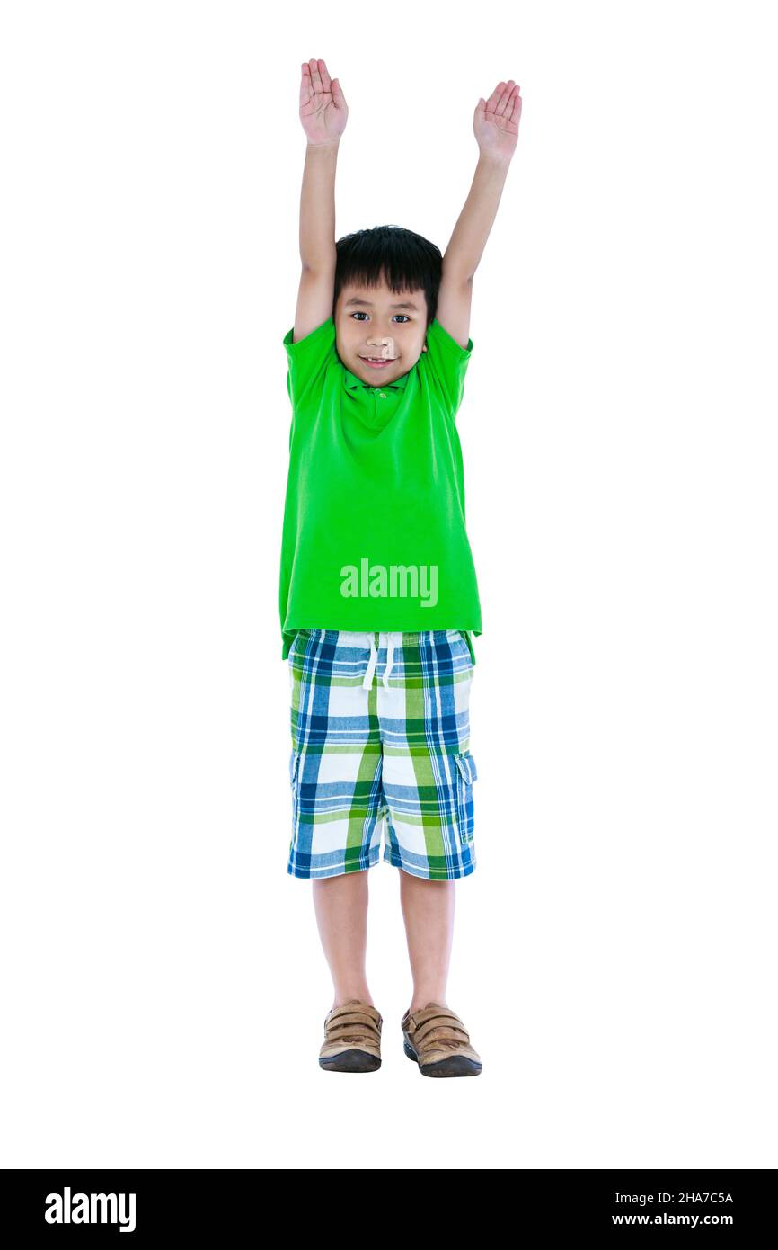 Full body of happy asian child smiling and raising his hands up, isolated on white background. Handsome child looking at camera. Positive human emotio Stock Photo