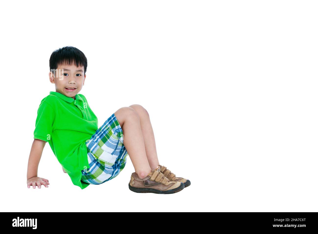 Full body of happy asian child smiling and looking at camera and free form copy space, isolated on white background. Positive human emotion, facial ex Stock Photo