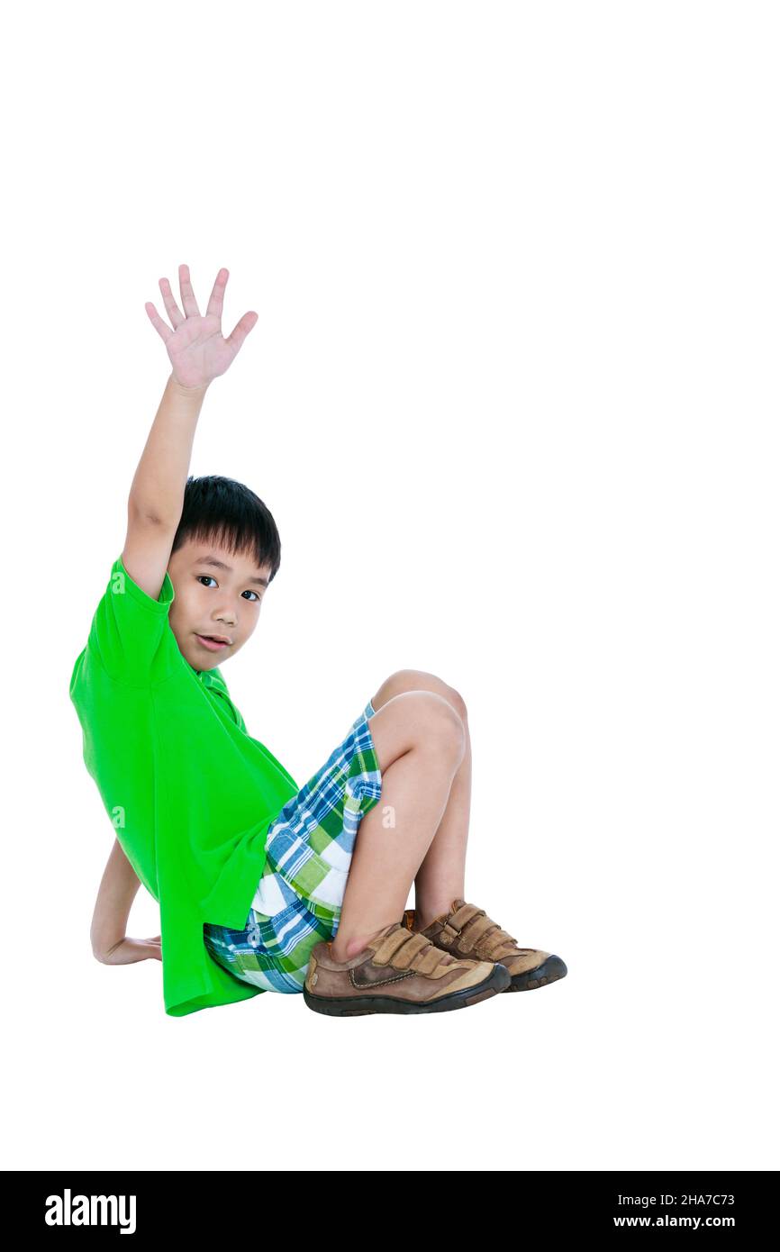 Full body of happy asian child smiling and raising his hands up, isolated on white background. Handsome child looking at camera. Positive human emotio Stock Photo