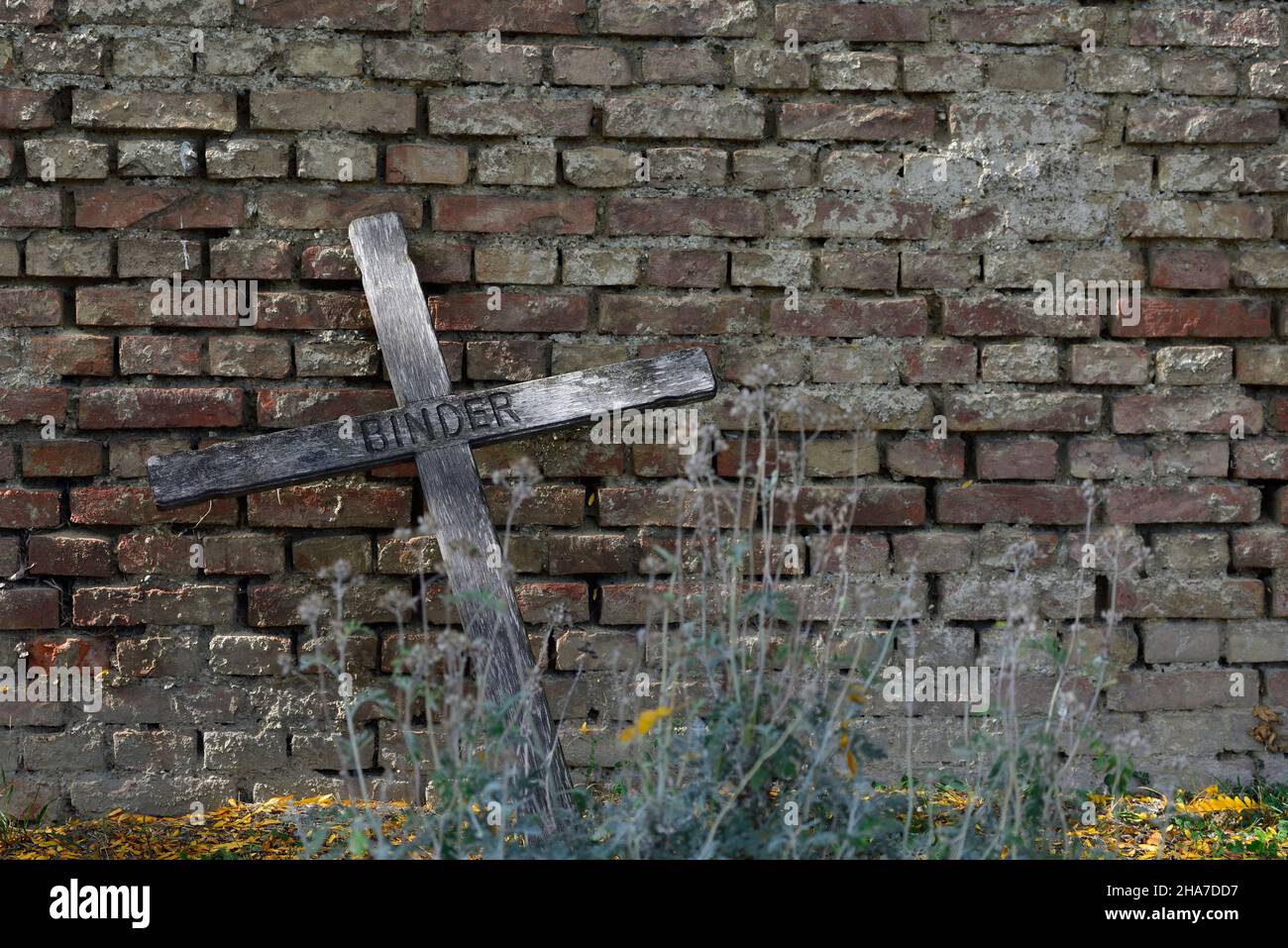 Vienna, Austria. The Vienna Central Cemetery. Grave sites at the central cemetery. Wooden cross on a brick wall Stock Photo