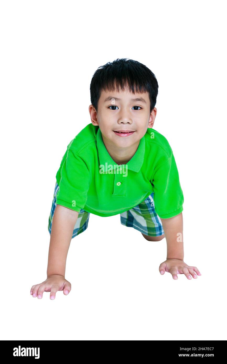 Happy child smiling and crawling on knees. Stylish asian boy having fun at studio. Isolated on white background. Studio shot. Positive human emotion. Stock Photo